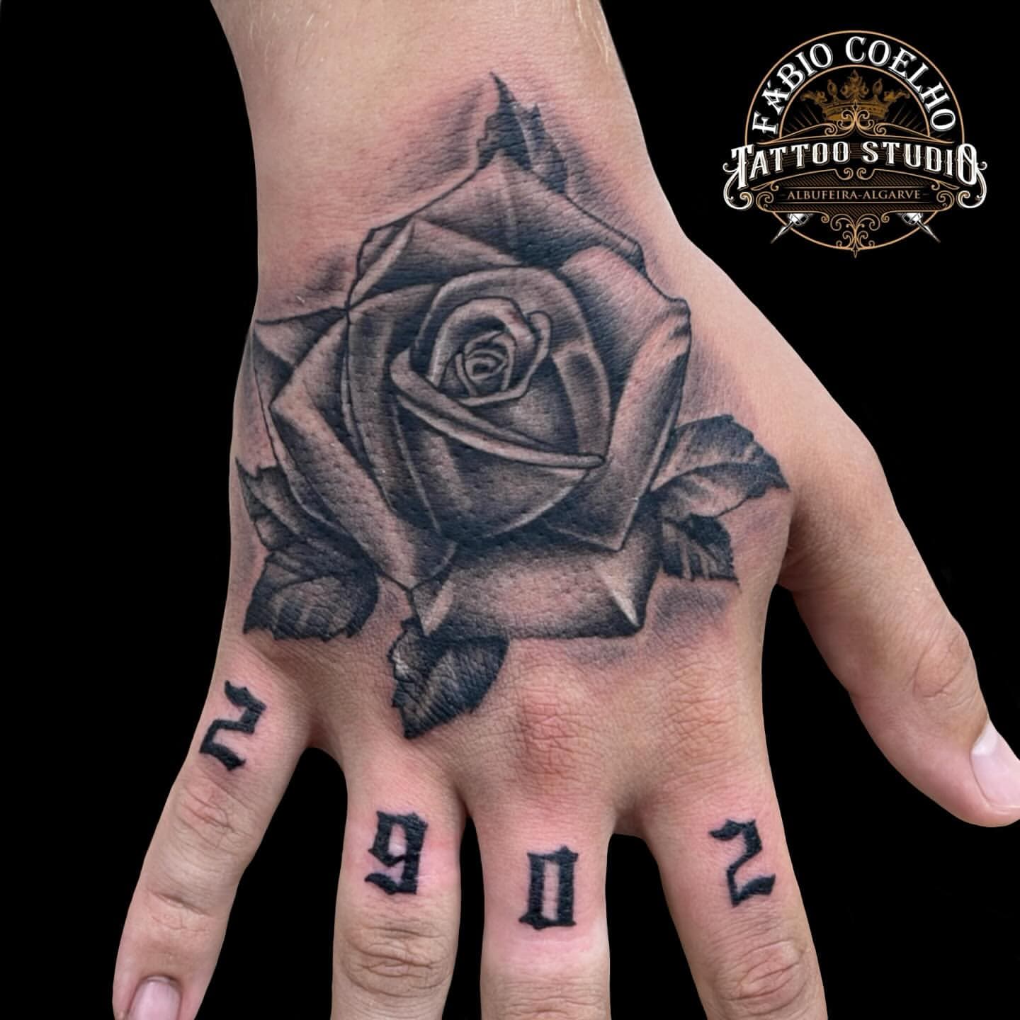 Black and grey rose on the hand